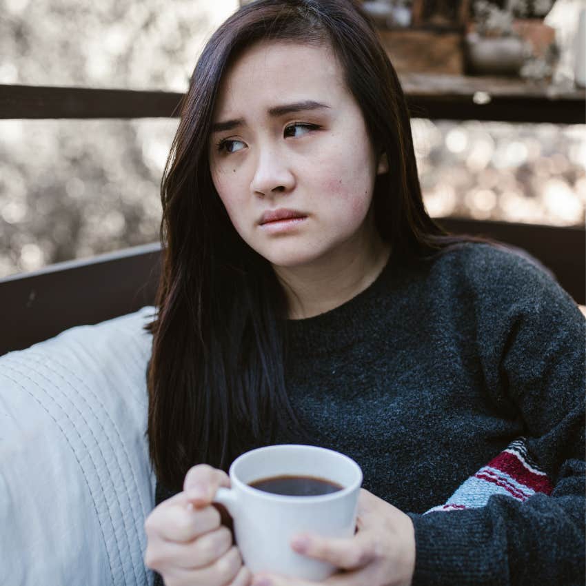 young woman looking uncomfortable after being left out by friends