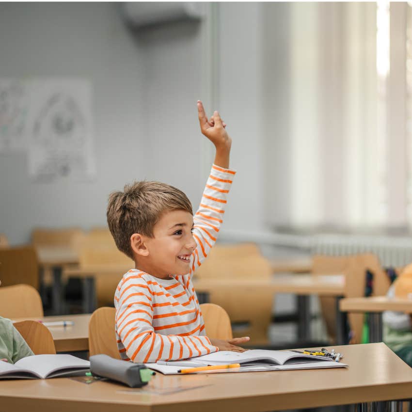 little boy raising his hand in class might get teased for speaking