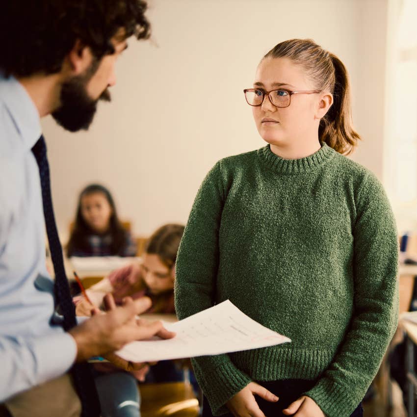 Young girl advocating for herself at school with a teacher