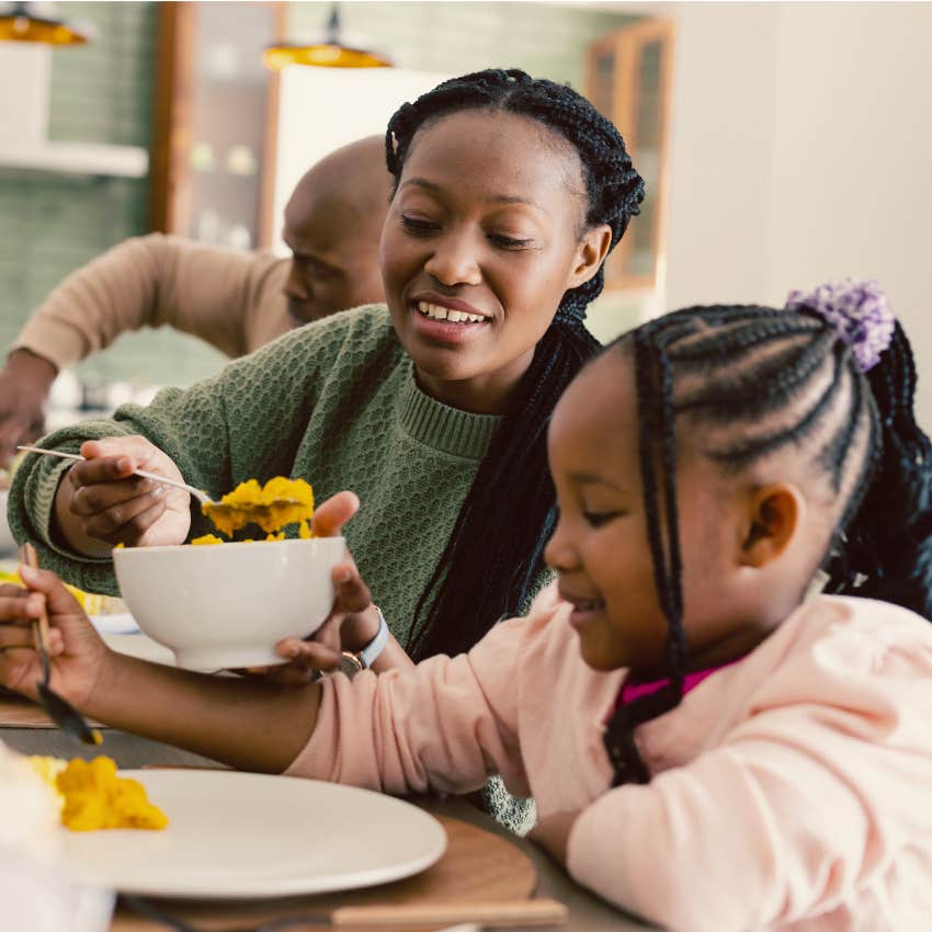 Little girl showing up for family dinner with her parents