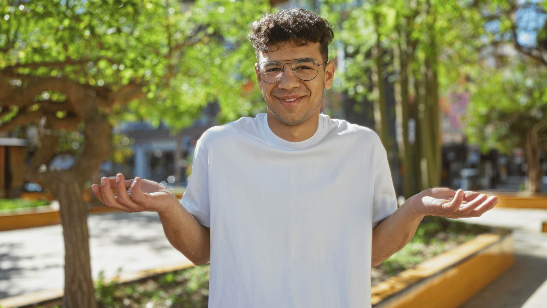 man in white shirt shrugging shoulders as he says everyone does it