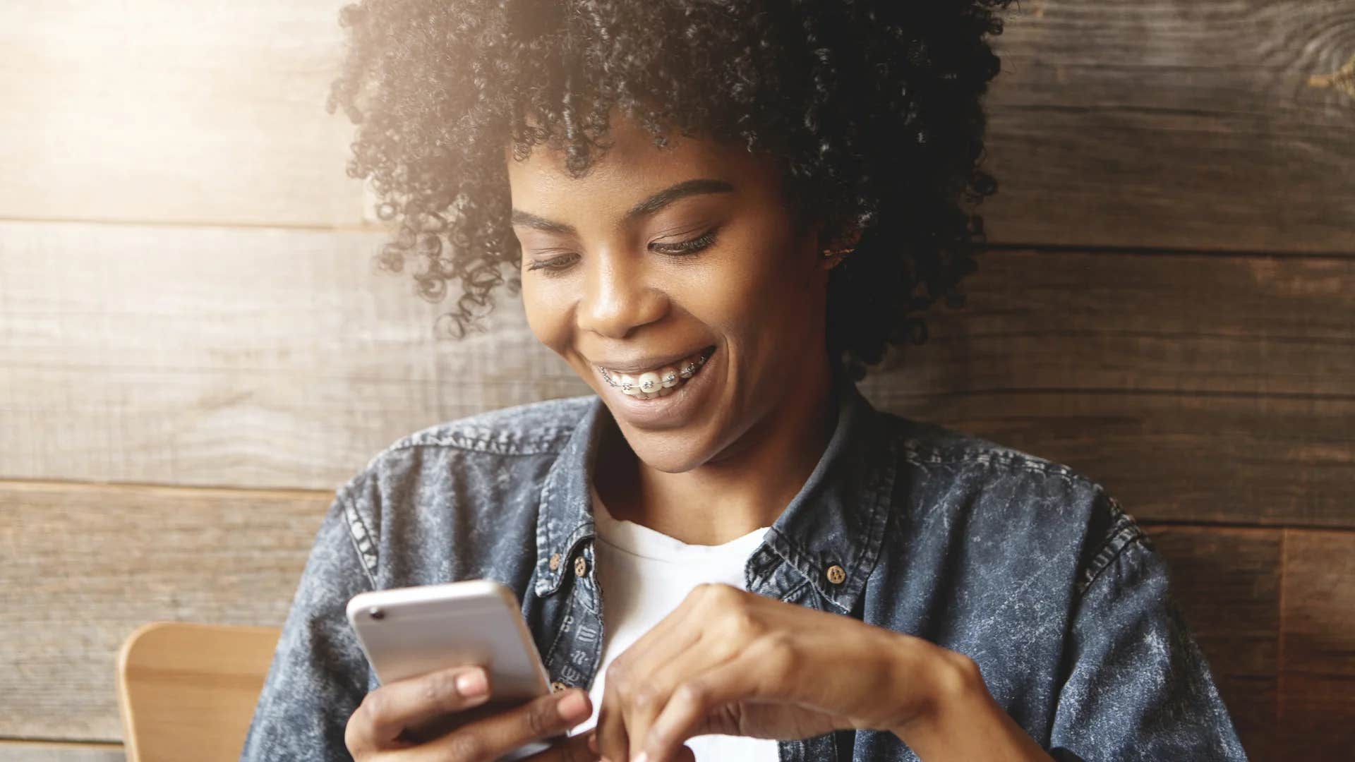 young woman on her phone posting on social media