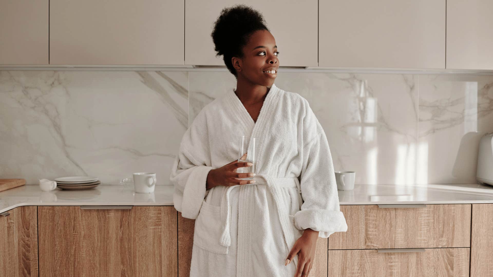 gen Z woman wearing a bath robe after taking an everything shower