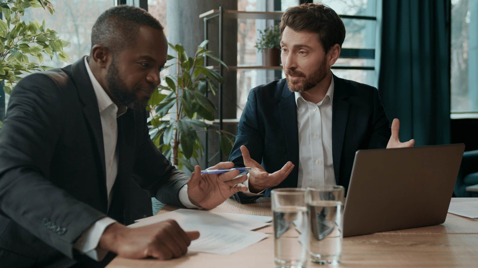 mentally emotionally genius man in suit asking coworker what do you think