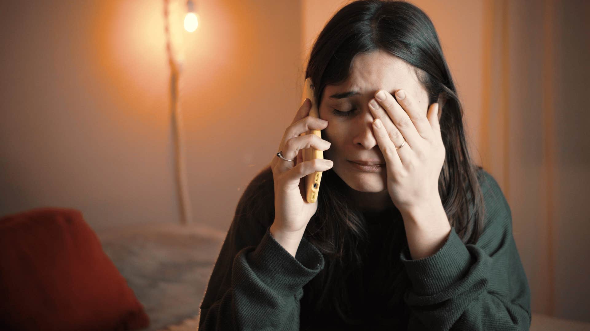 woman upset on the phone as she thinks why am i always the bad guy