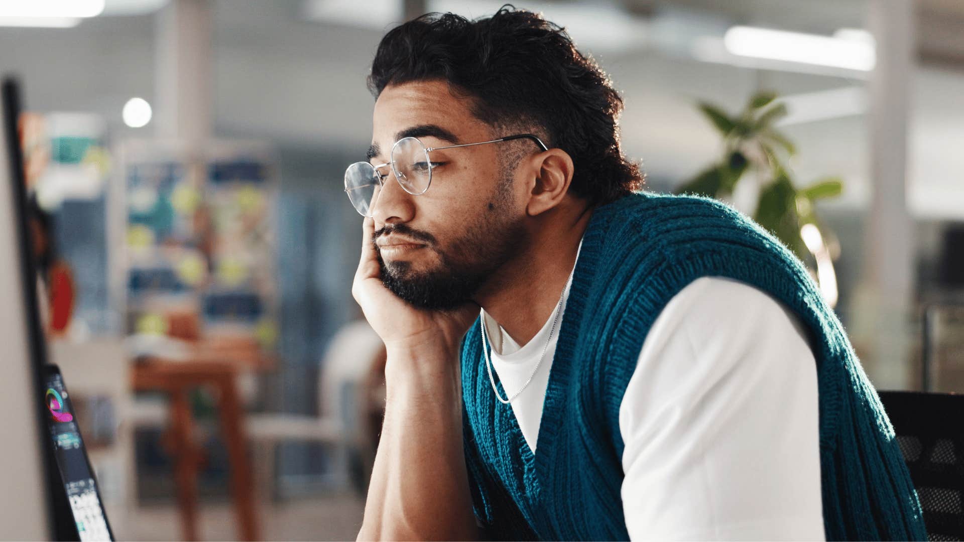 man staring at laptop unamused as he thinks i'll worry about that tomorrow