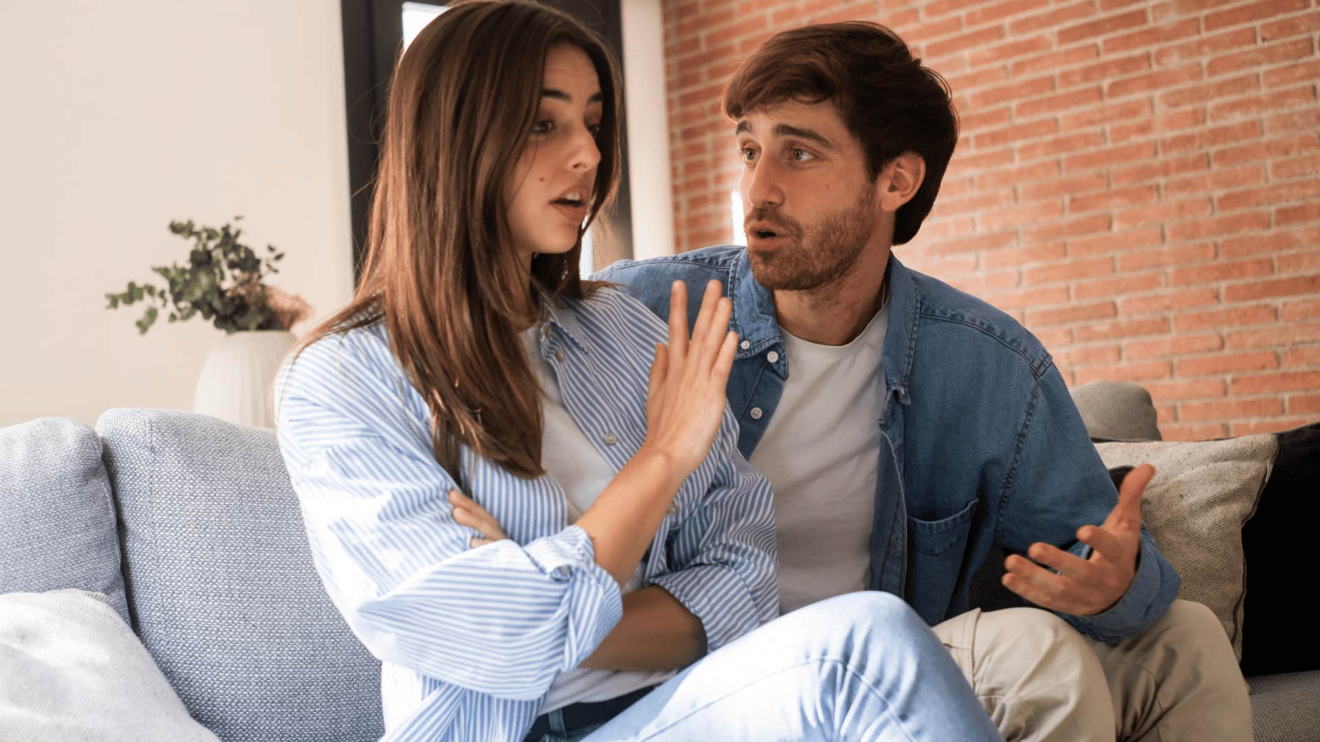 woman in white shirt holding up hand to man as she tells him i hate being told what to do