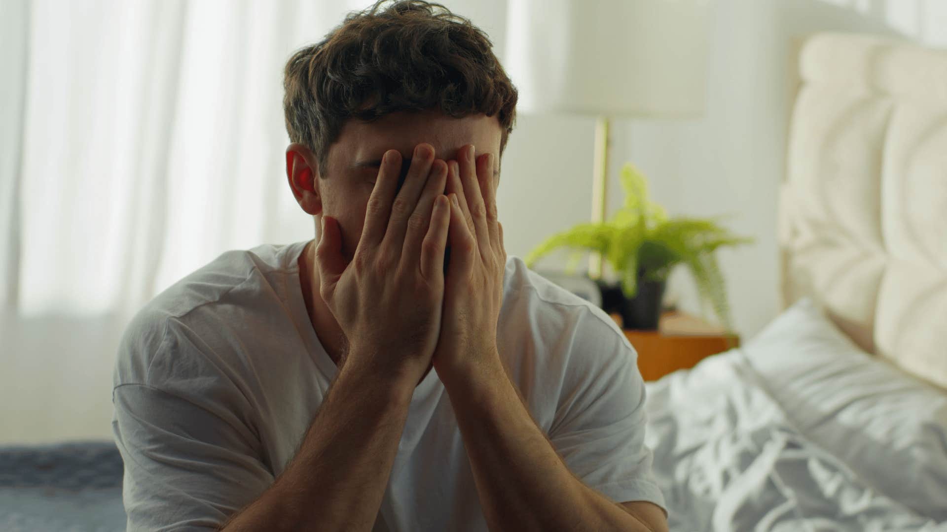man covering his face upset as he thinks i'm so sick of everything
