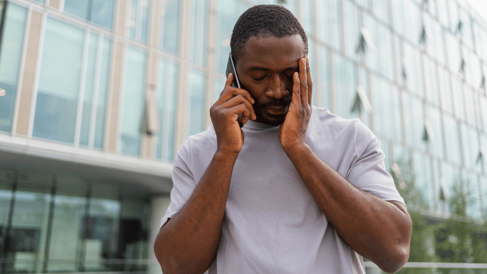 man in gray shirt exhausted on phone as he thinks i don't have the energy for this