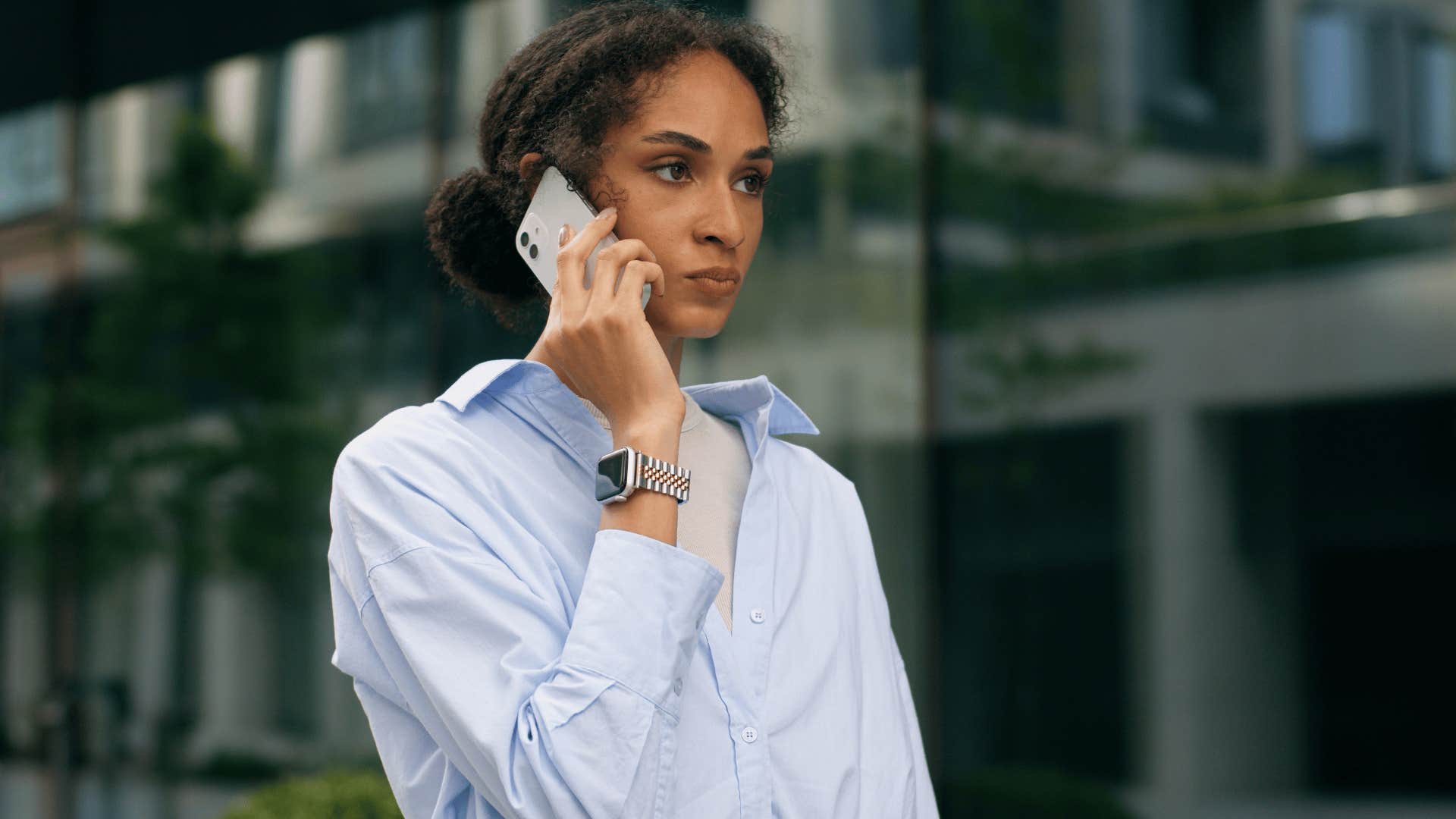 woman in blue shirt on the phone annoyed as she answers back whatever you want