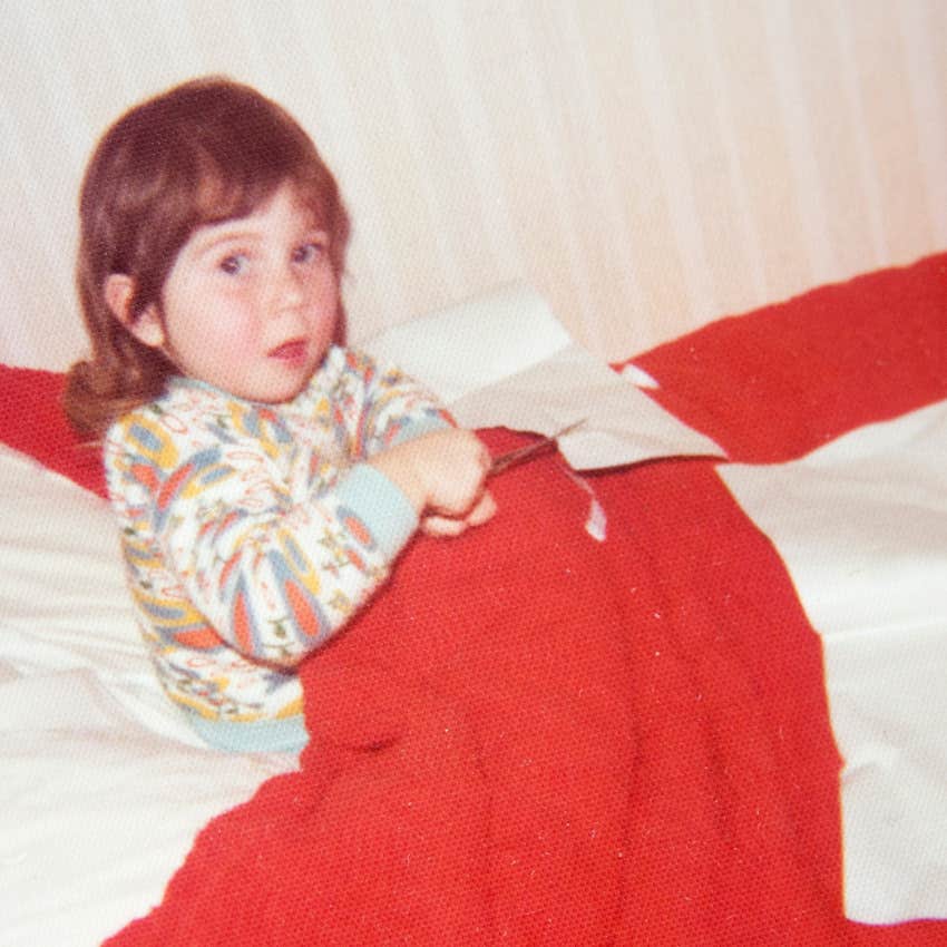 little girl cutting paper herself because she can't rely on anyone