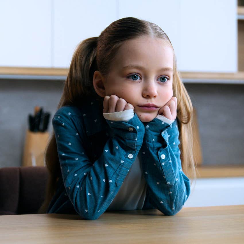 Little girl sitting alone and not being coddled at home.