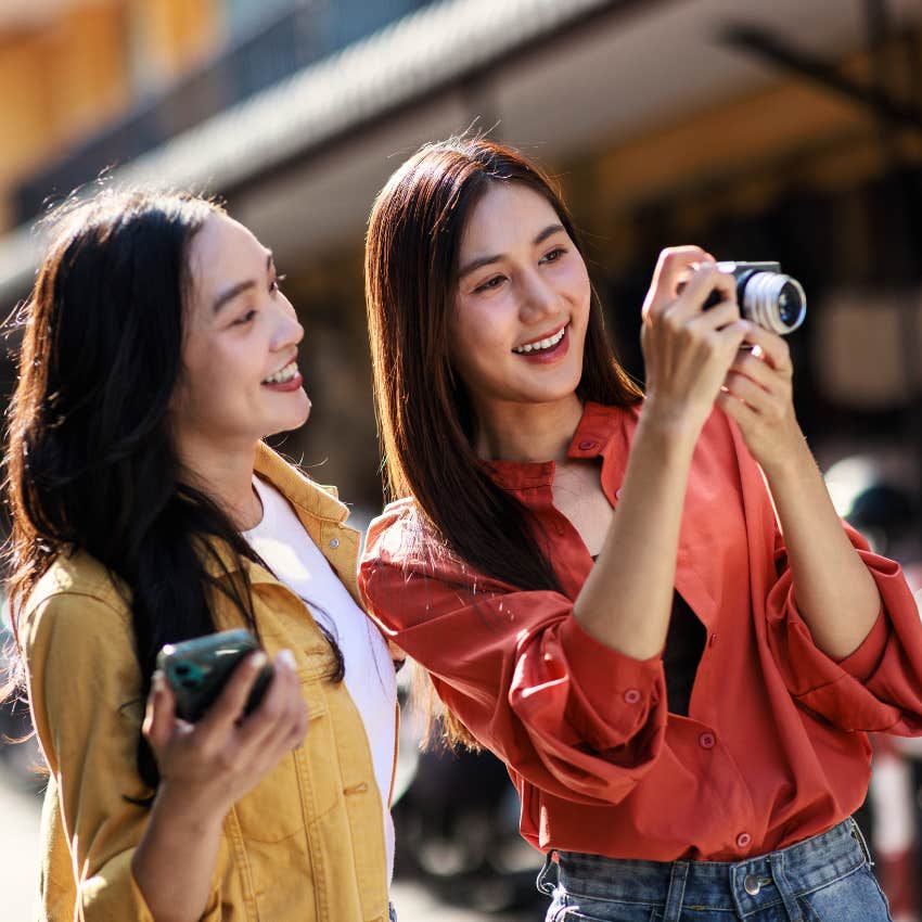 young women taking the perfect picture on a camera
