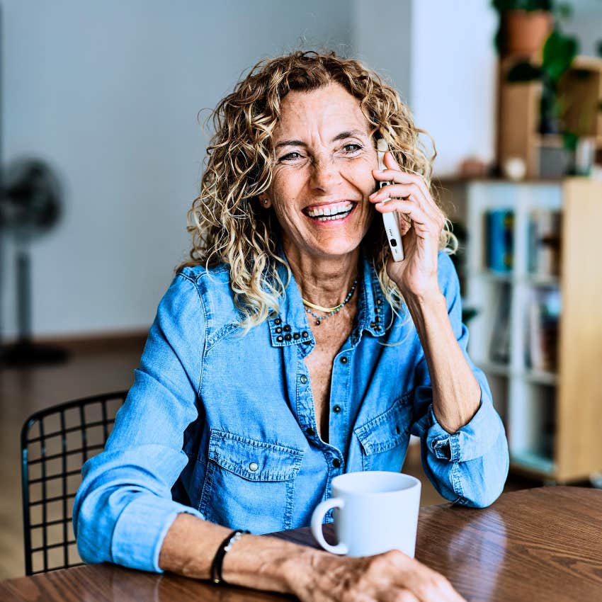 Woman smiling about unexpected phone calls and visits