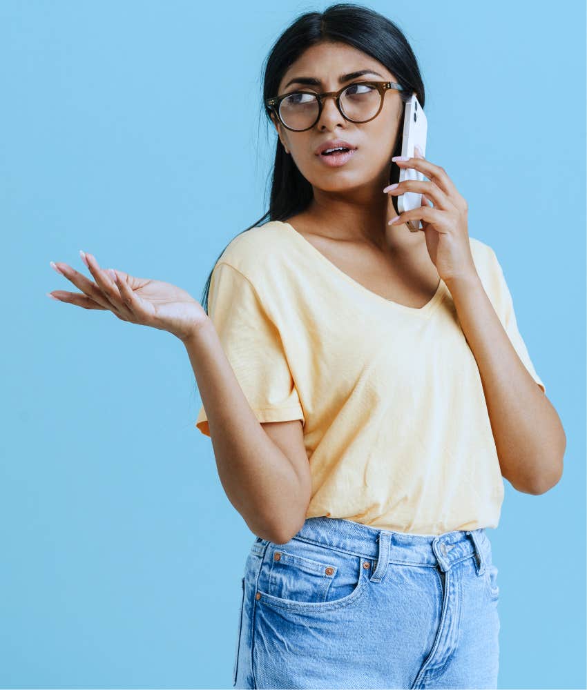 Woman raised by low effort parents showing self-sufficiency on the phone 