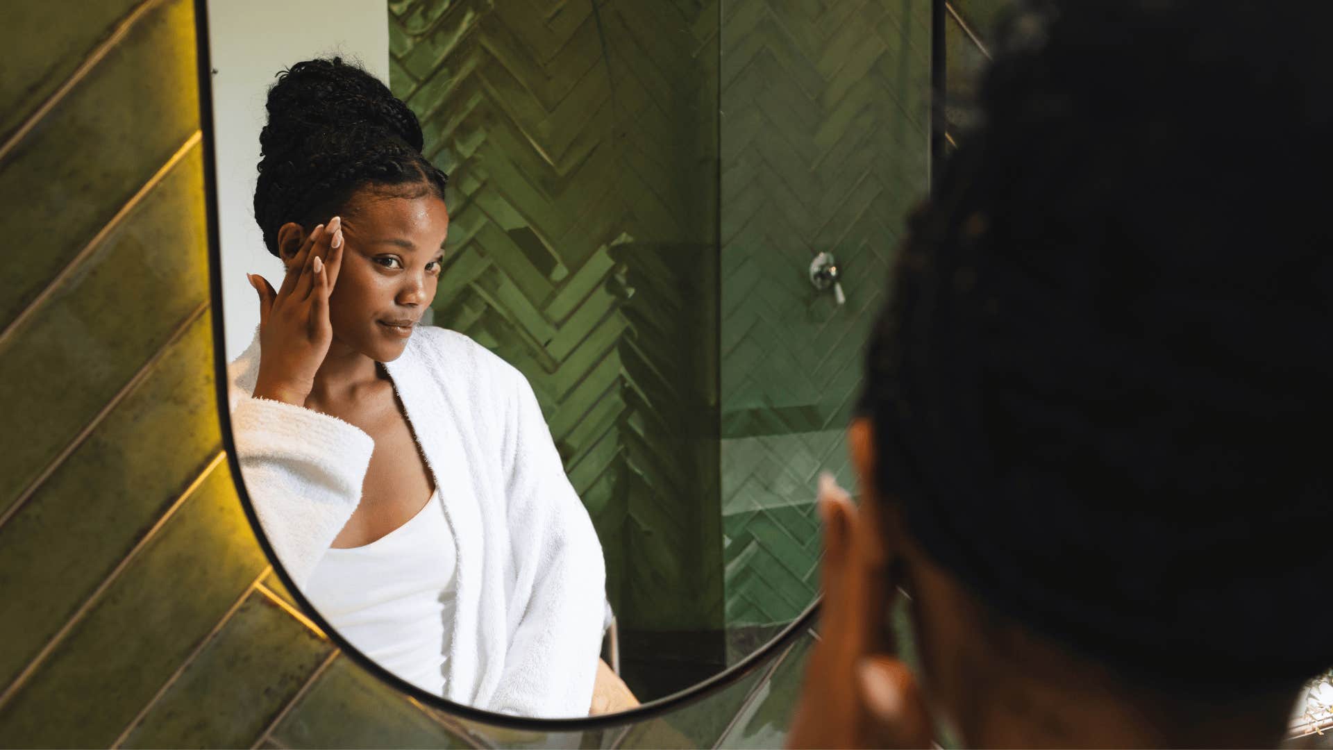 woman in favorite white fuzzy robe looking in mirror confident
