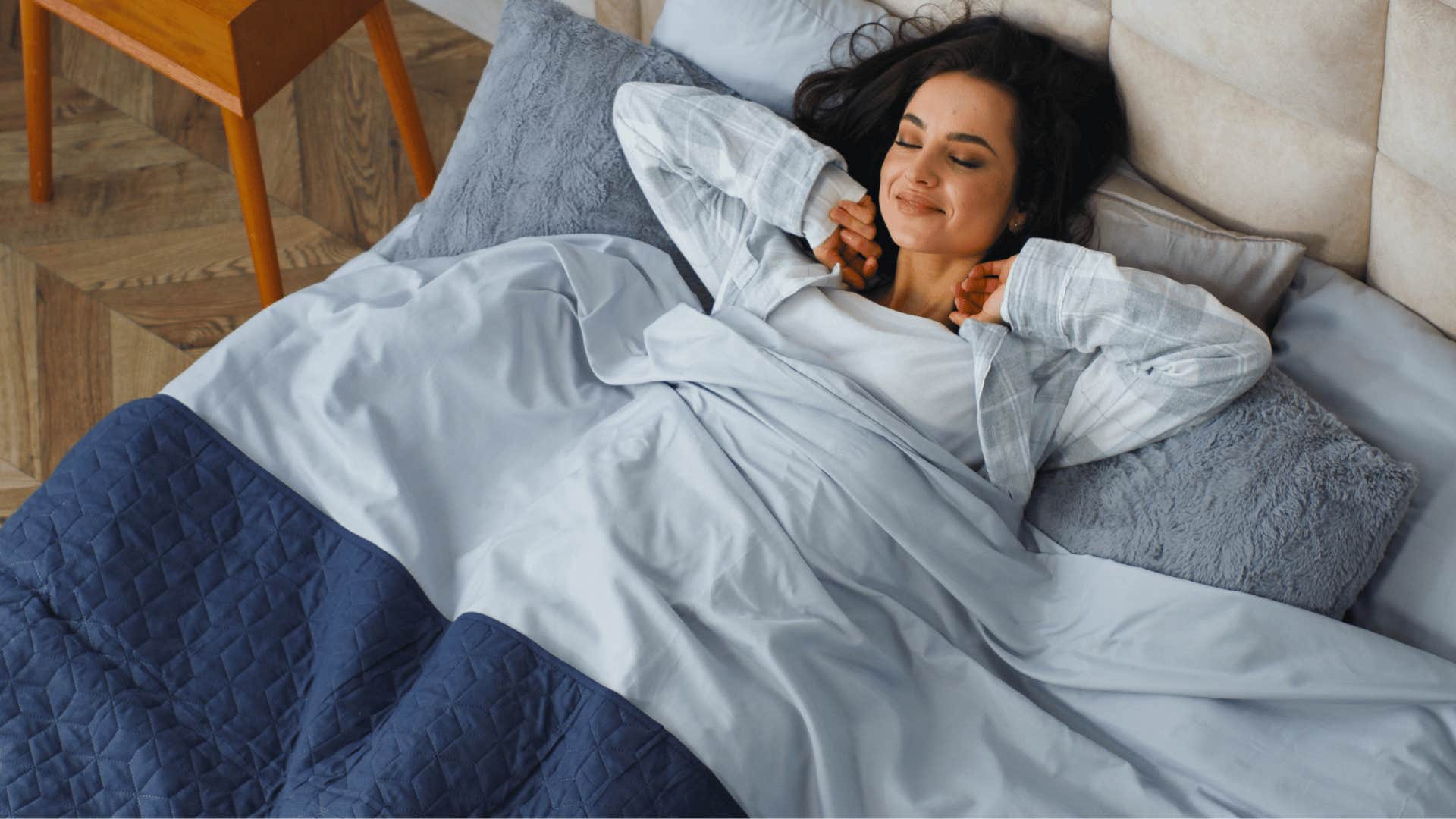 woman stretching on the bed in clean comfortable bedding