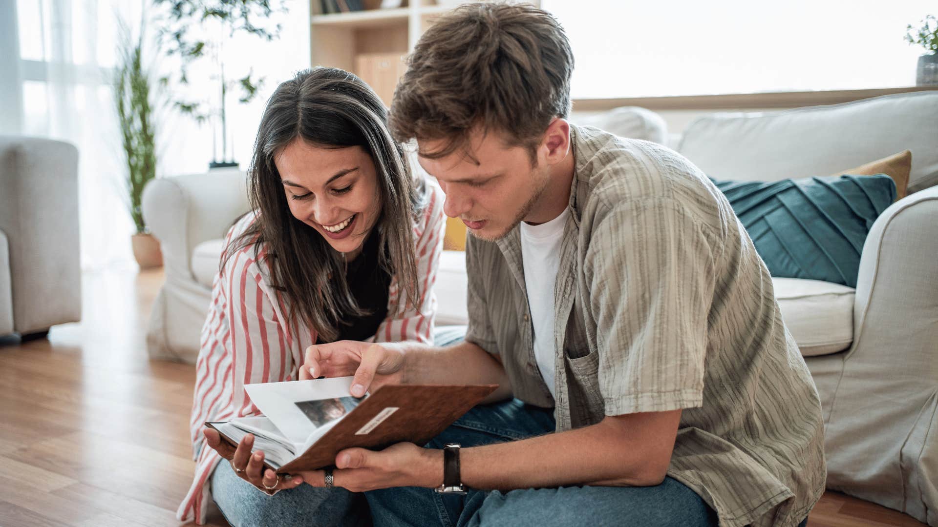 couple looking at photo album together as it's something that instantly makes them feel at home