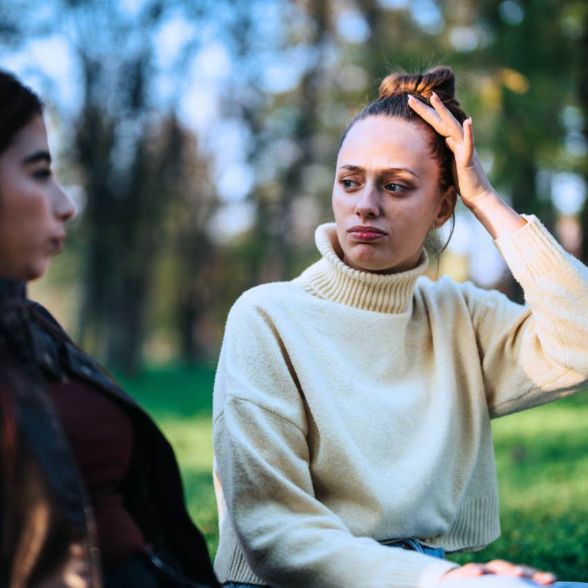 confused woman telling friend I don't know about that during conversation