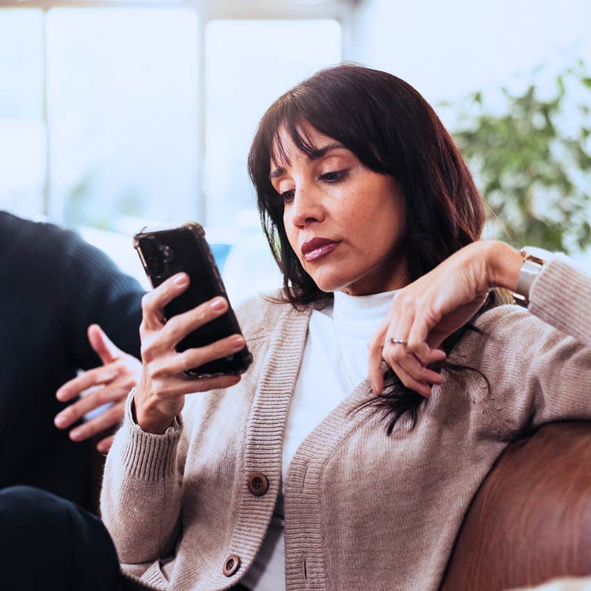 woman texting whatever you want on her phone at home