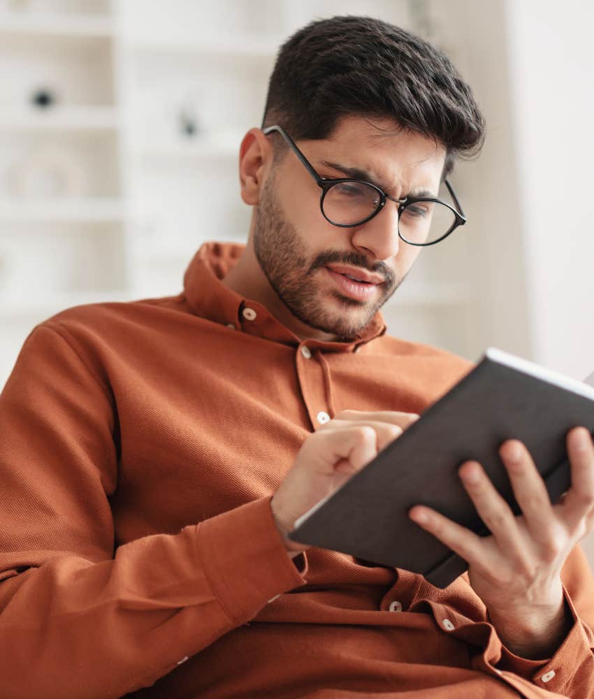 man who is morally self-righteous looking judgmentally at a journal 