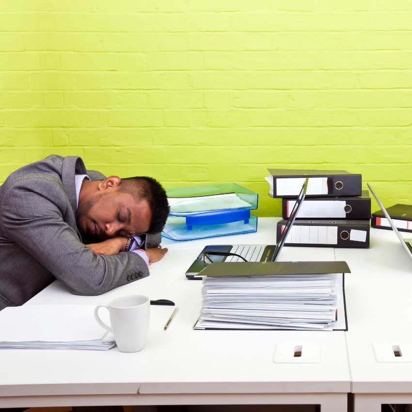 Man sleeping at his desk because he stayed up too late