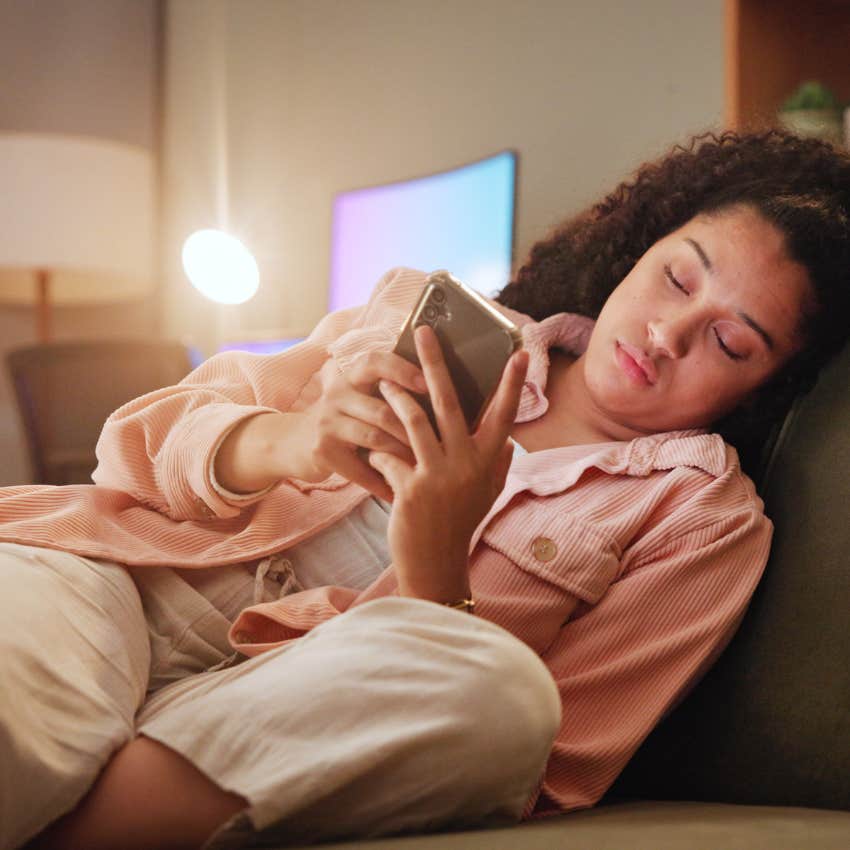 woman staying in for the night on her phone