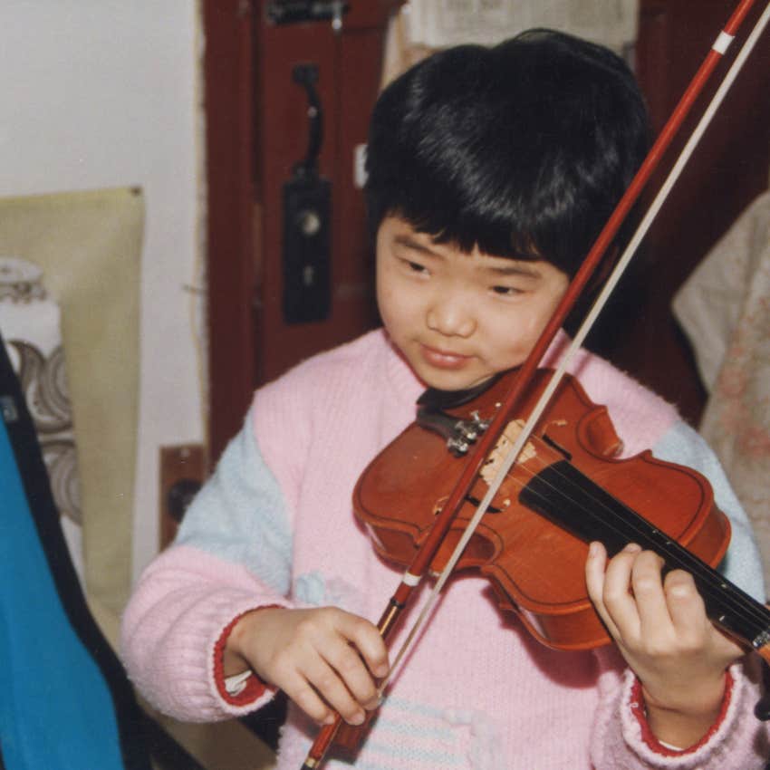 boy learning to play the violin