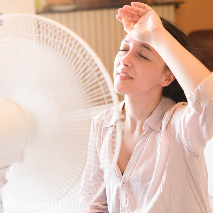 woman turning off the ac to save money