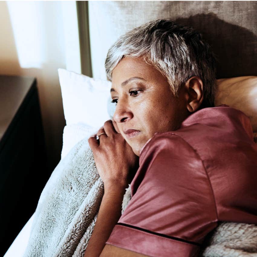 Woman losing freedom and lying in bed at home.
