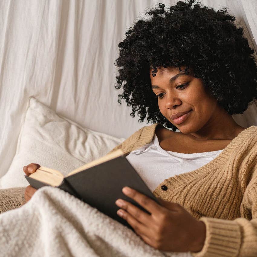 woman staying up too late reading