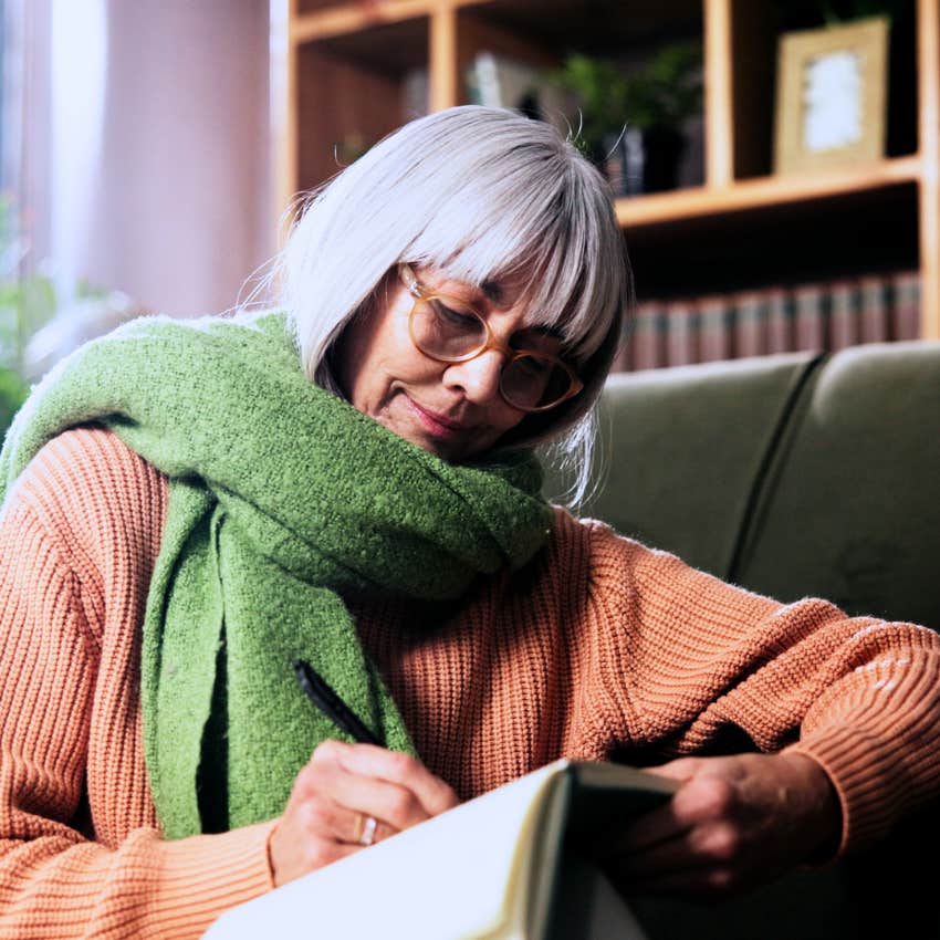 woman writing in a journal for peace