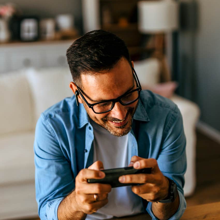 happy man playing video games at home for peace