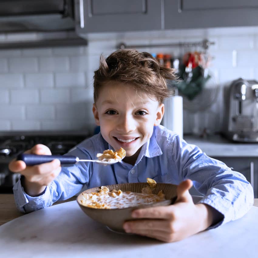 little boy cooking for himself at home alone