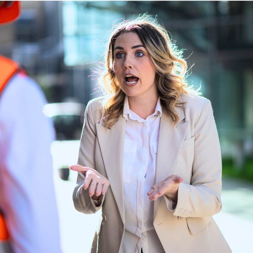 Woman saying "you're not the boss of me" to her co-worker outside.