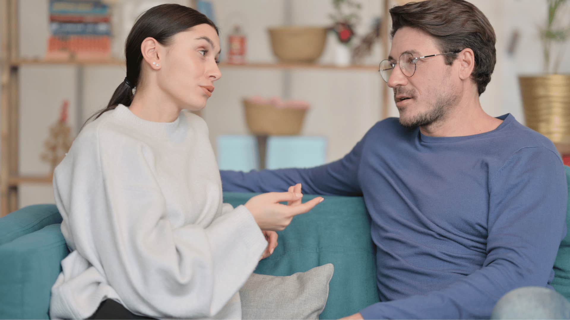 woman in white shirt asking man in blue shirt are you sure you're not mad at me