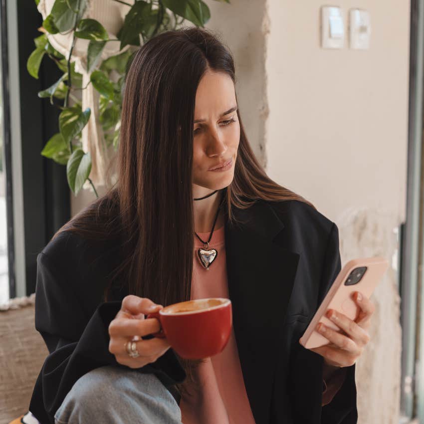 selective woman drinking coffee choosing to ignore a call instead of answering