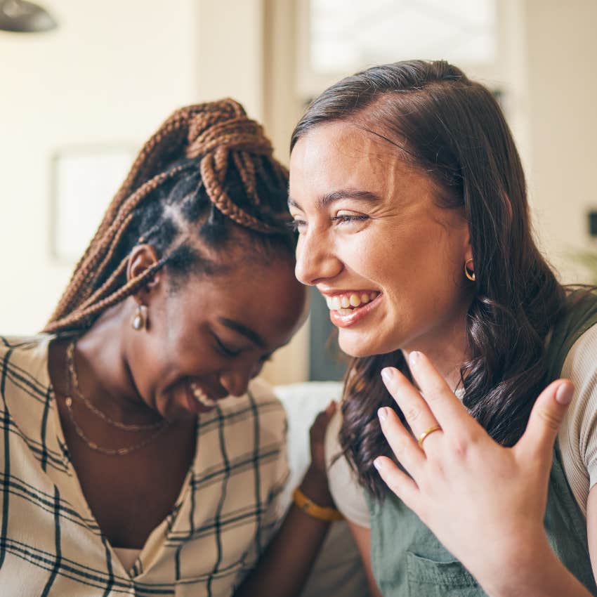 lucky woman smiling with her friend saying let's see what happens