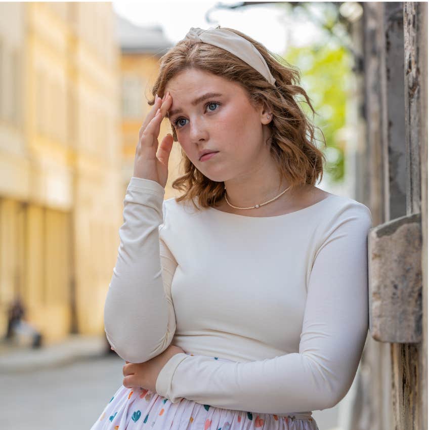 woman slowly losing mental emotional patience trying to pass of it's fine while holding her head