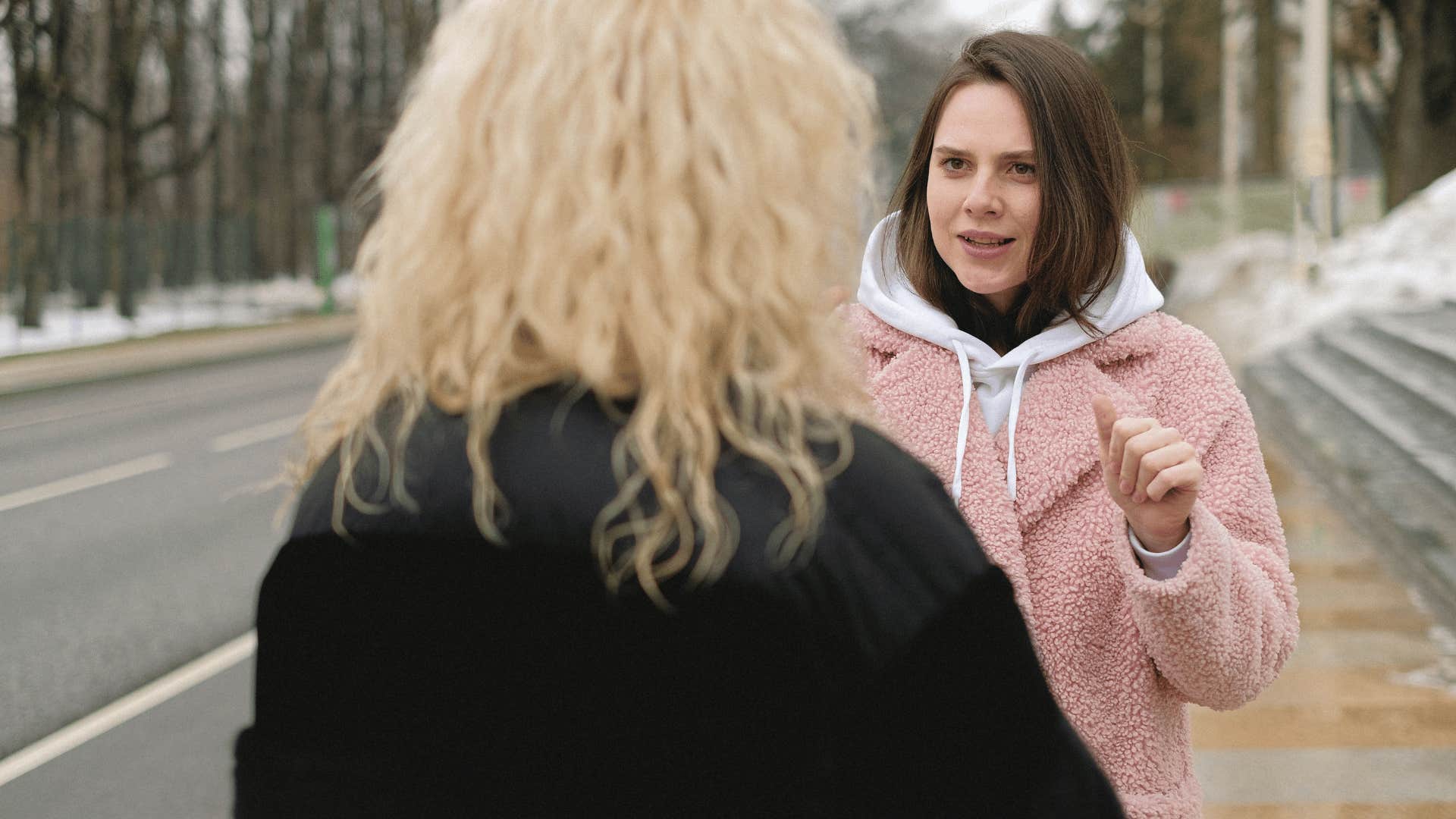 angry woman talking to friend and calling her crazy