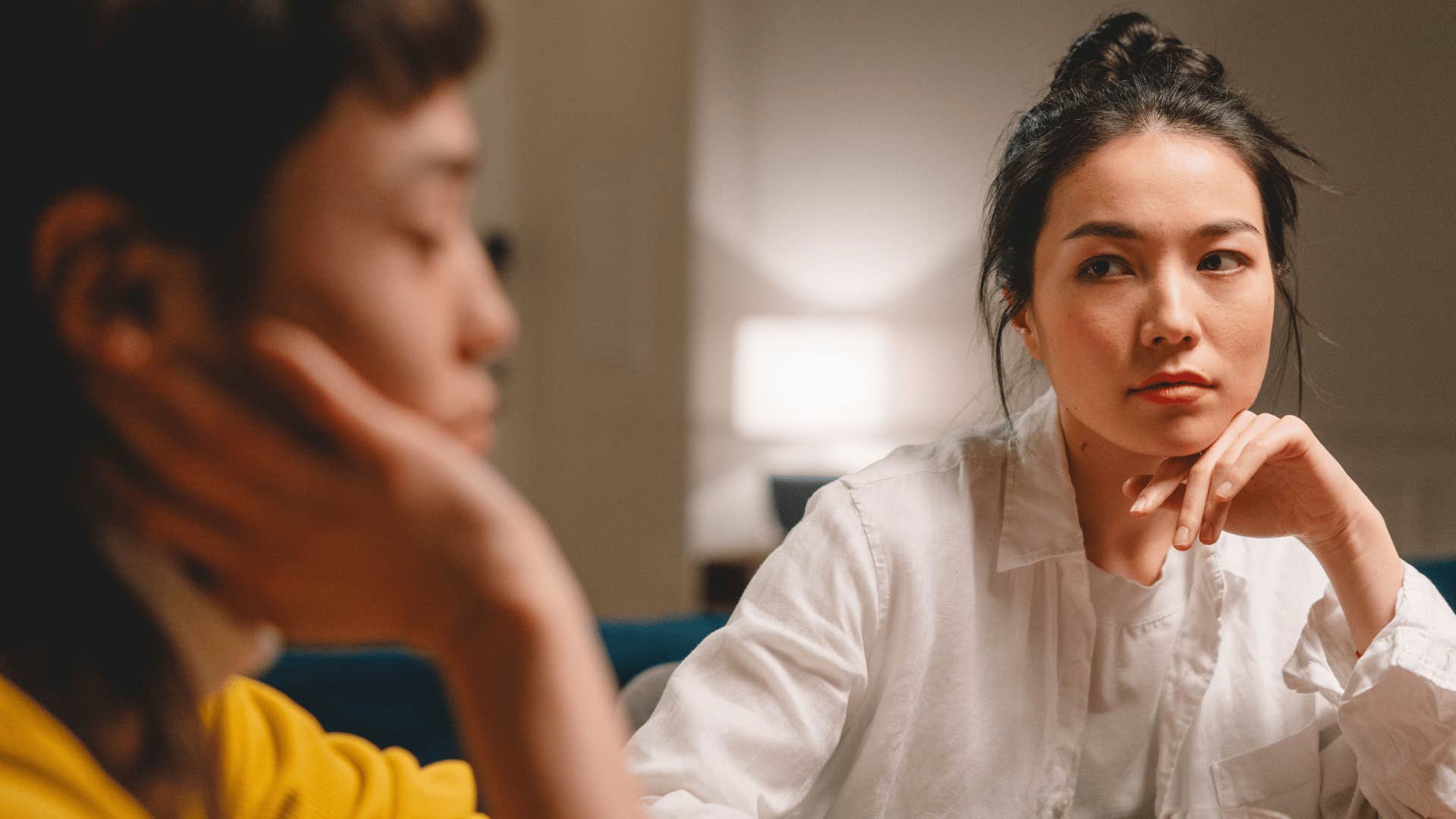woman seething with anger looking at partner saying she's fine