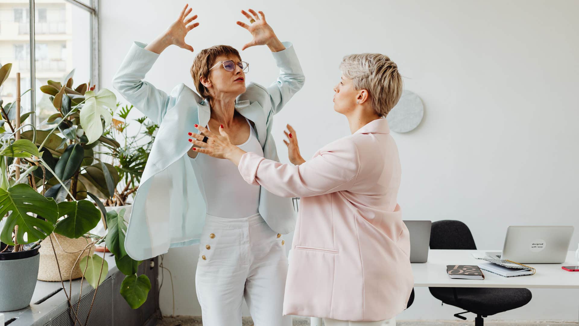 angry woman crashing out at work yelling at colleague