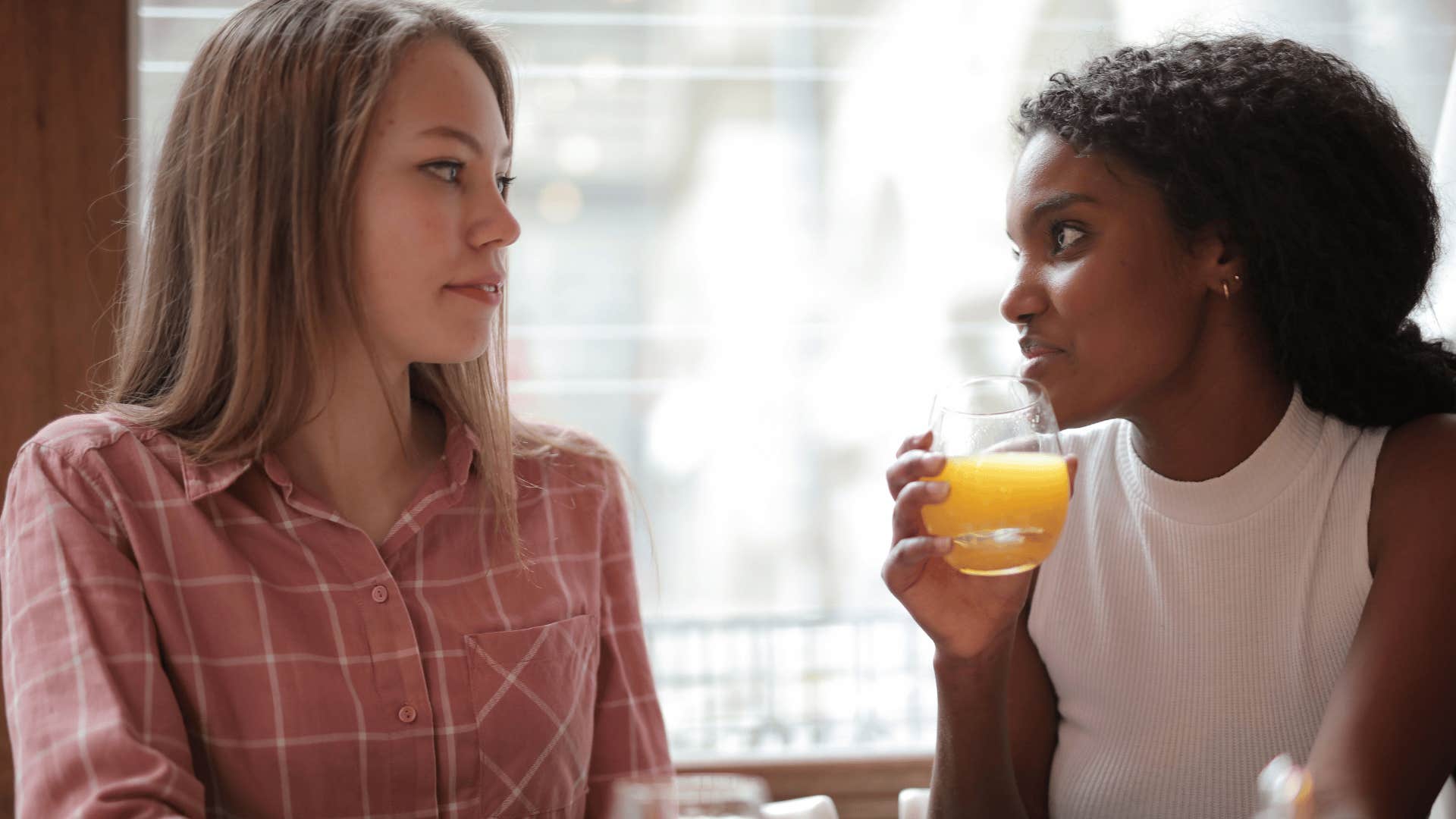 friends having breakfast woman telling other woman she seems upset