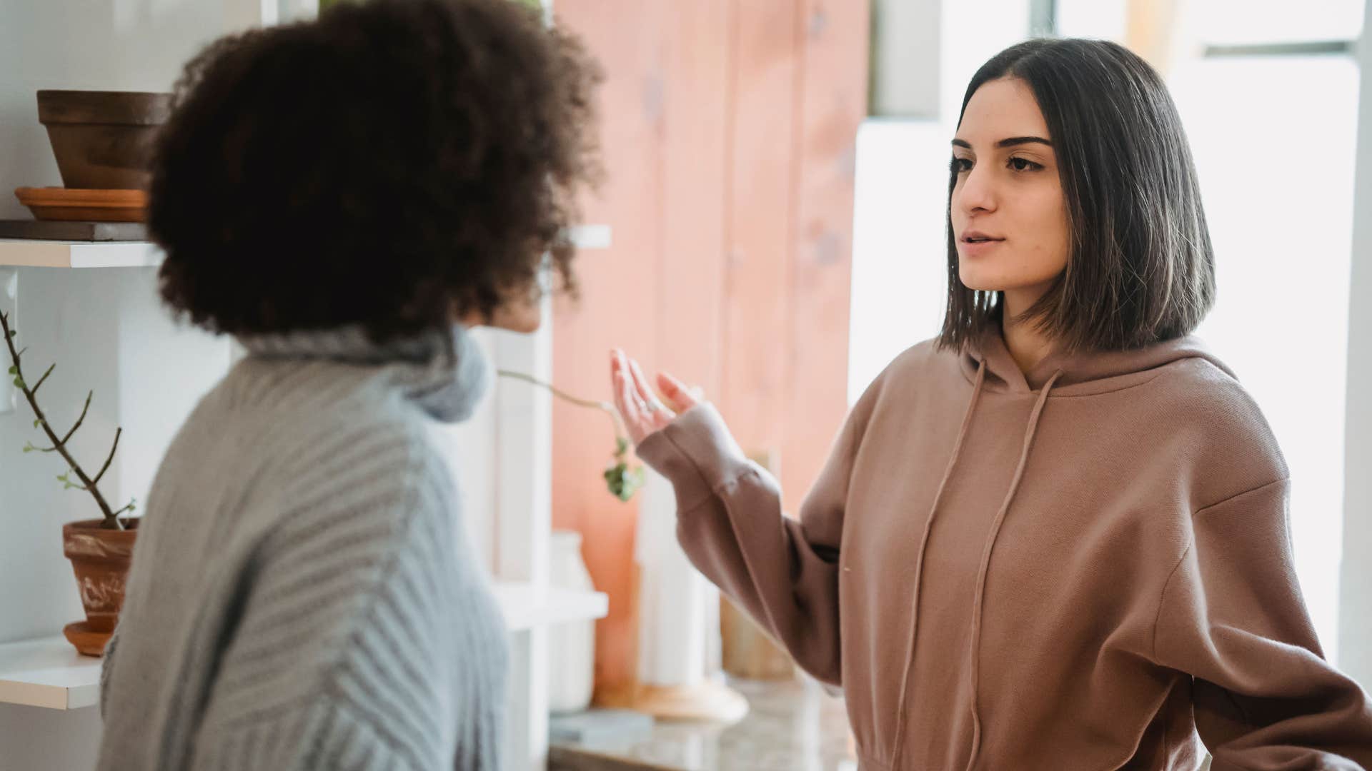 intelligent woman apologizing to friend for being distracted