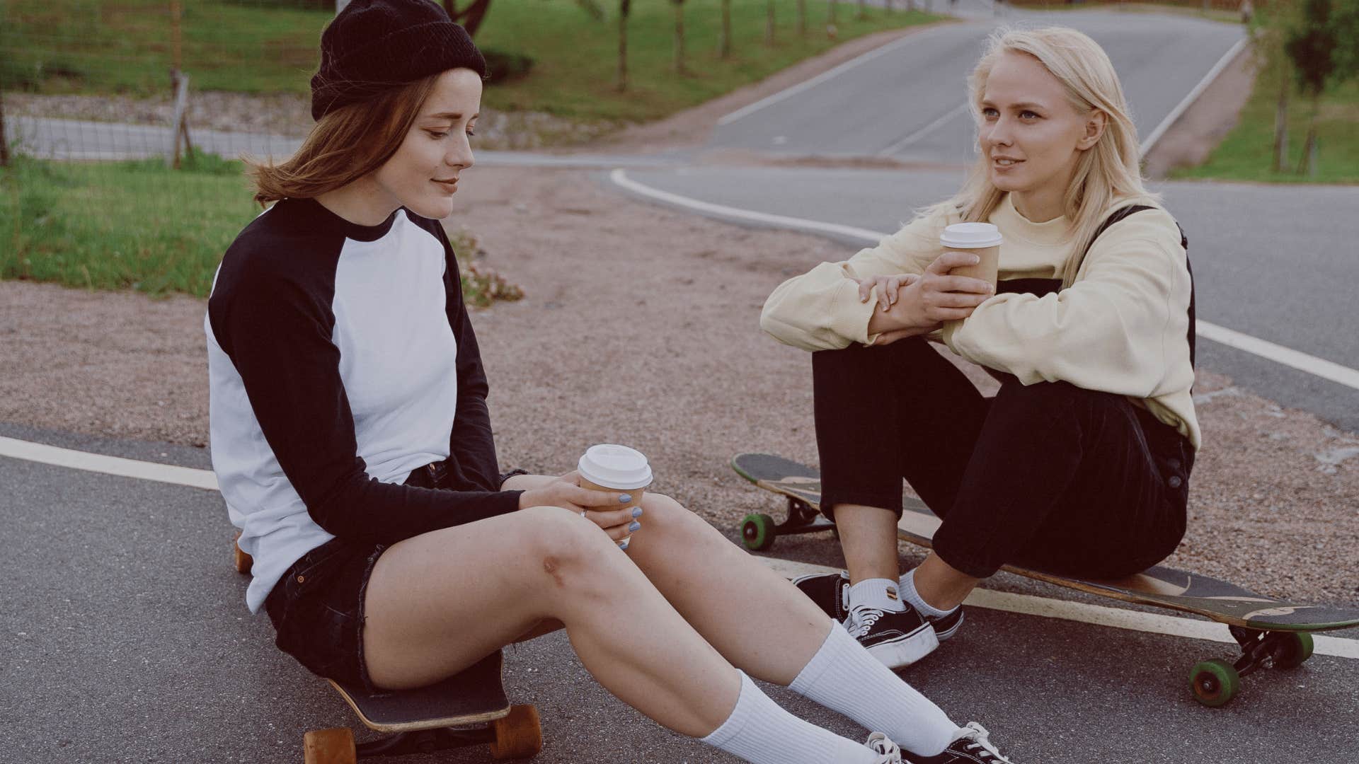 friends sitting on skateboards talking