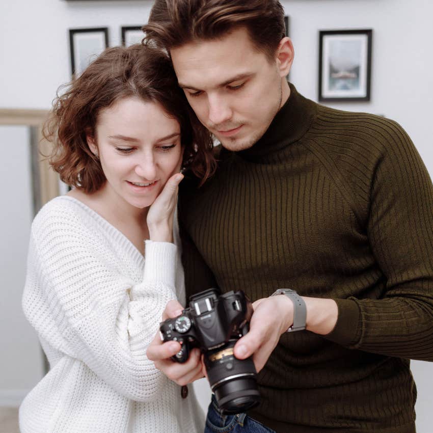 nerdy man showing partner his hobby of photography