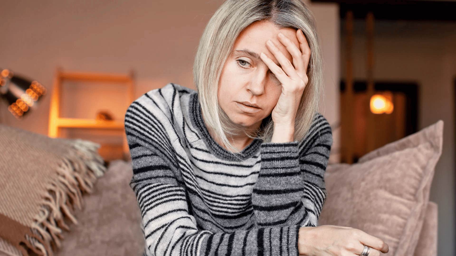 emotionally vulnerable middle aged woman looking stressed at home