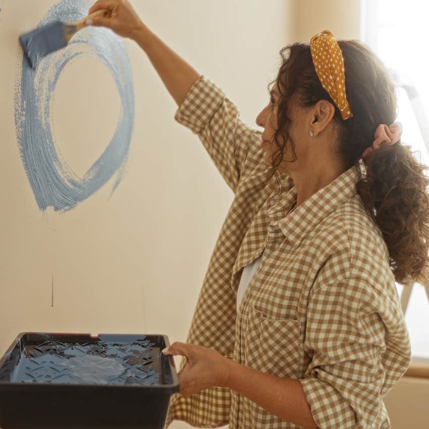 woman repainting her home after a difficult chapter ended