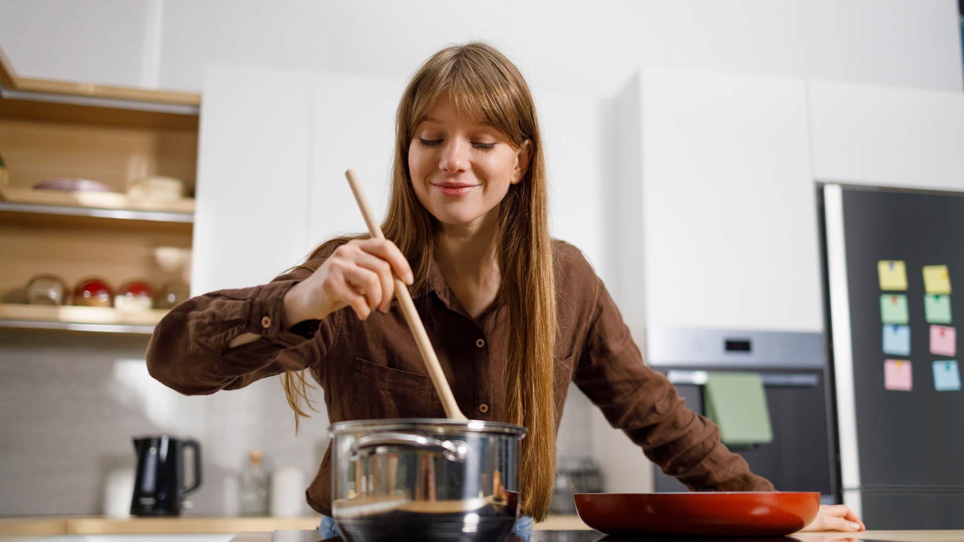 millennial woman raised in the 80s and 90s cooking a meal
