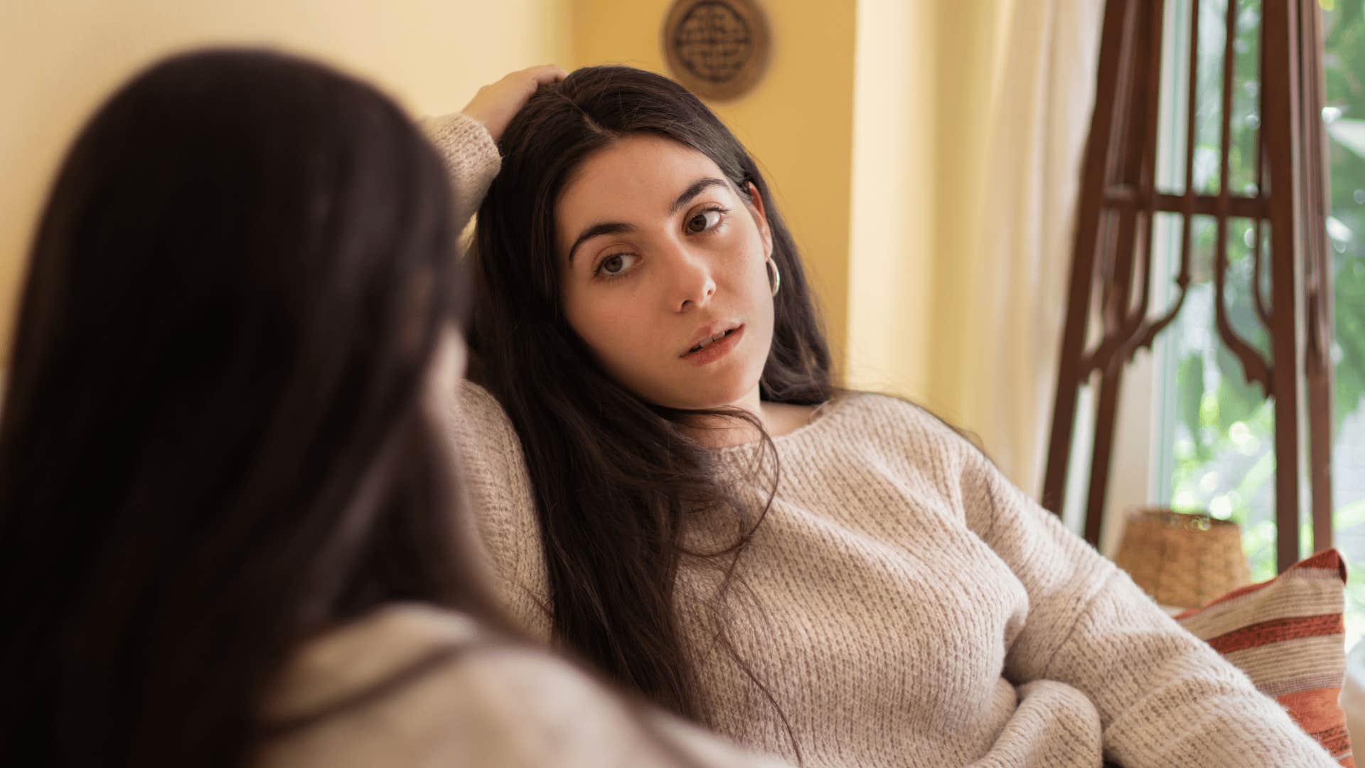 woman looking at other woman annoyed as she thinks i don't have the energy to make new friends